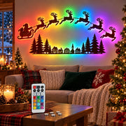 RGB LED Christmas wall lights featuring Santa's sleigh and flying reindeer with colorful backlighting in a cozy living room, remote control on the coffee table.