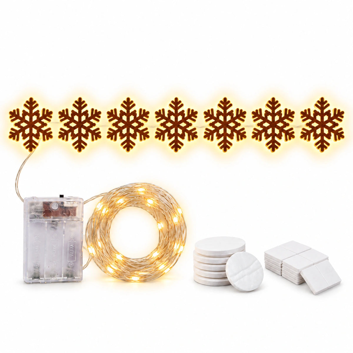 Warm white LED snowflake Christmas light string with seven glowing snowflake shapes, a battery box, coiled fairy lights and adhesive mounting accessories.