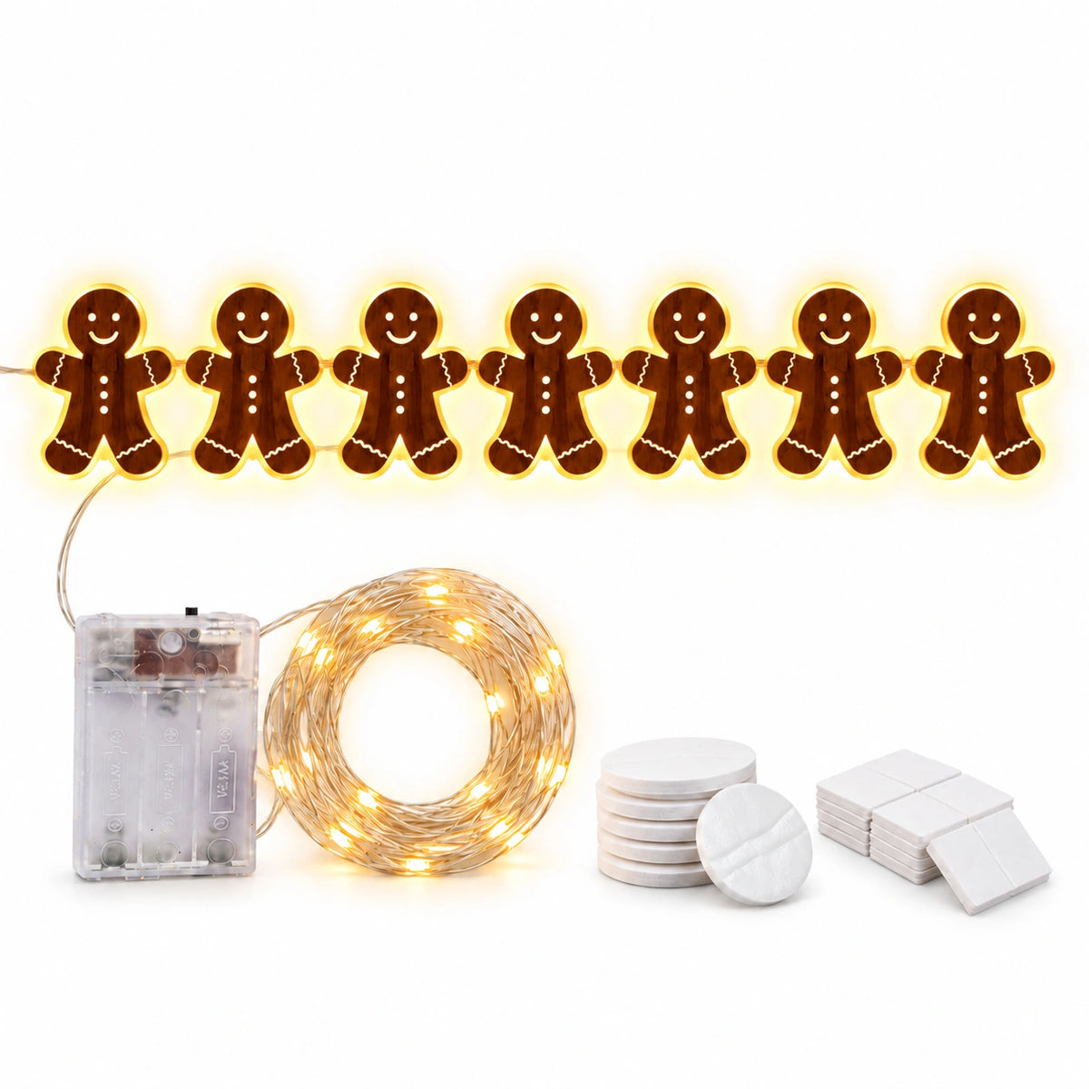 Warm white LED gingerbread man Christmas lights featuring seven smiling gingerbread figures, a battery box, coiled string lights and adhesive mounting pads.