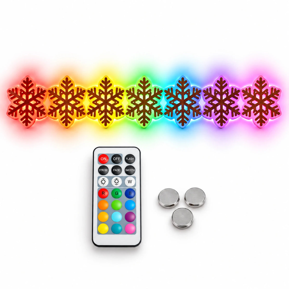 Set of seven RGB LED snowflake Christmas wall lights with colorful glowing outlines, displayed with a remote control and three batteries on a white background.