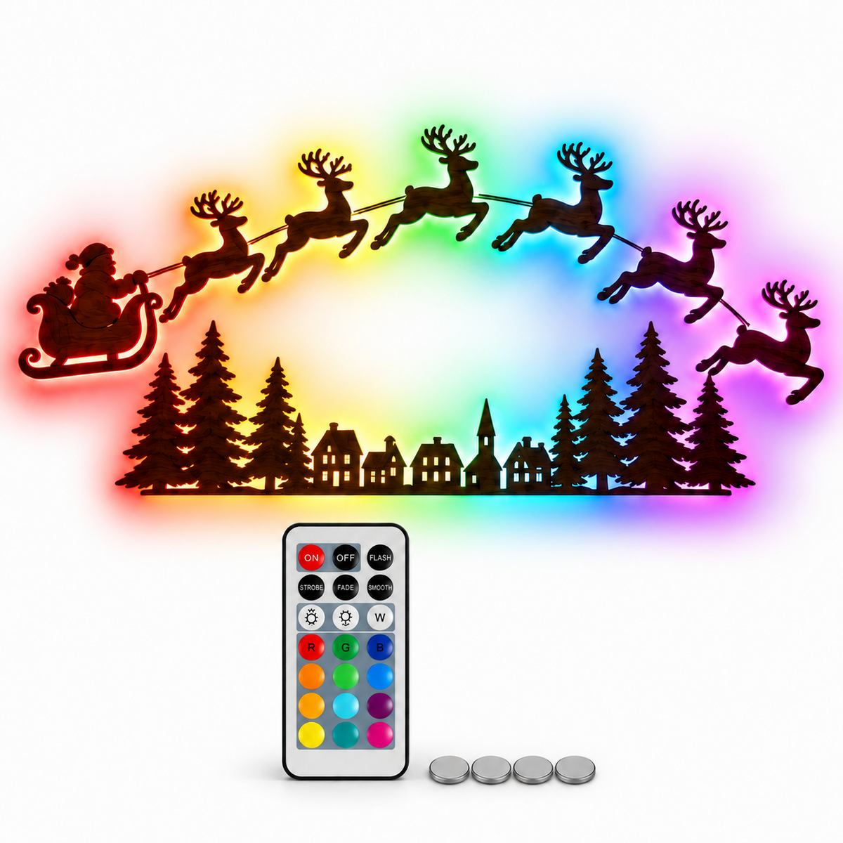 RGB LED Christmas wall lights featuring Santa's sleigh, flying reindeer and a Christmas village forest silhouette, with remote control and batteries on a white background.