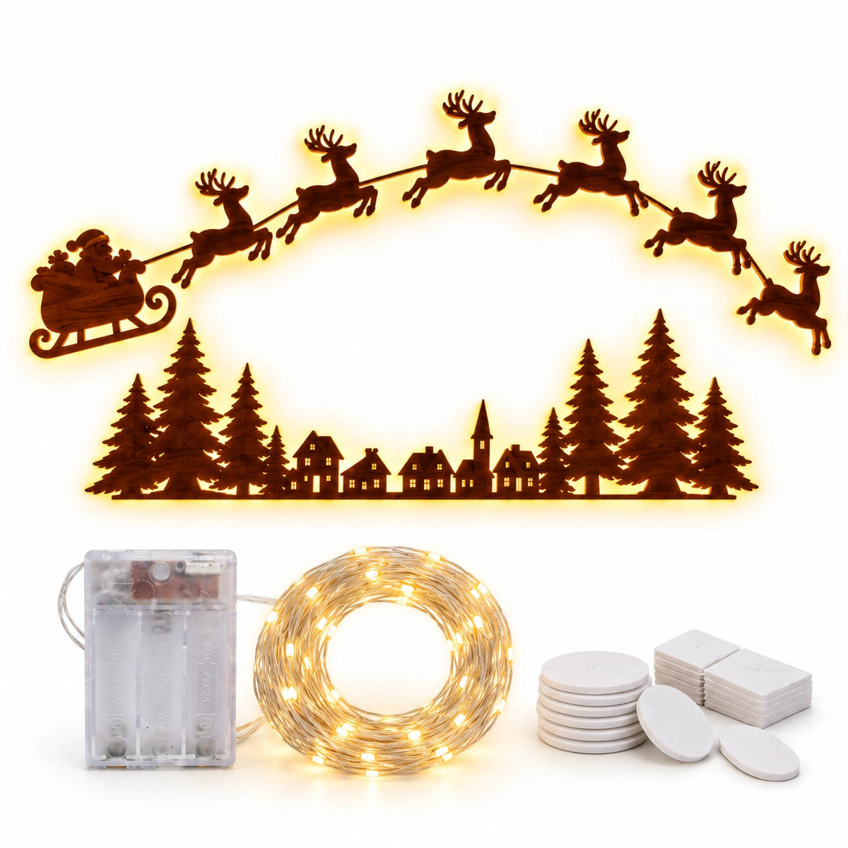 Warm white LED Christmas wall decoration featuring Santa's sleigh and flying reindeer above a festive village and pine forest silhouette, with battery box, coiled lights and adhesive mounting pads.